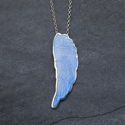 Blue Enamelled Angel Wing Pendant on a grey slate background