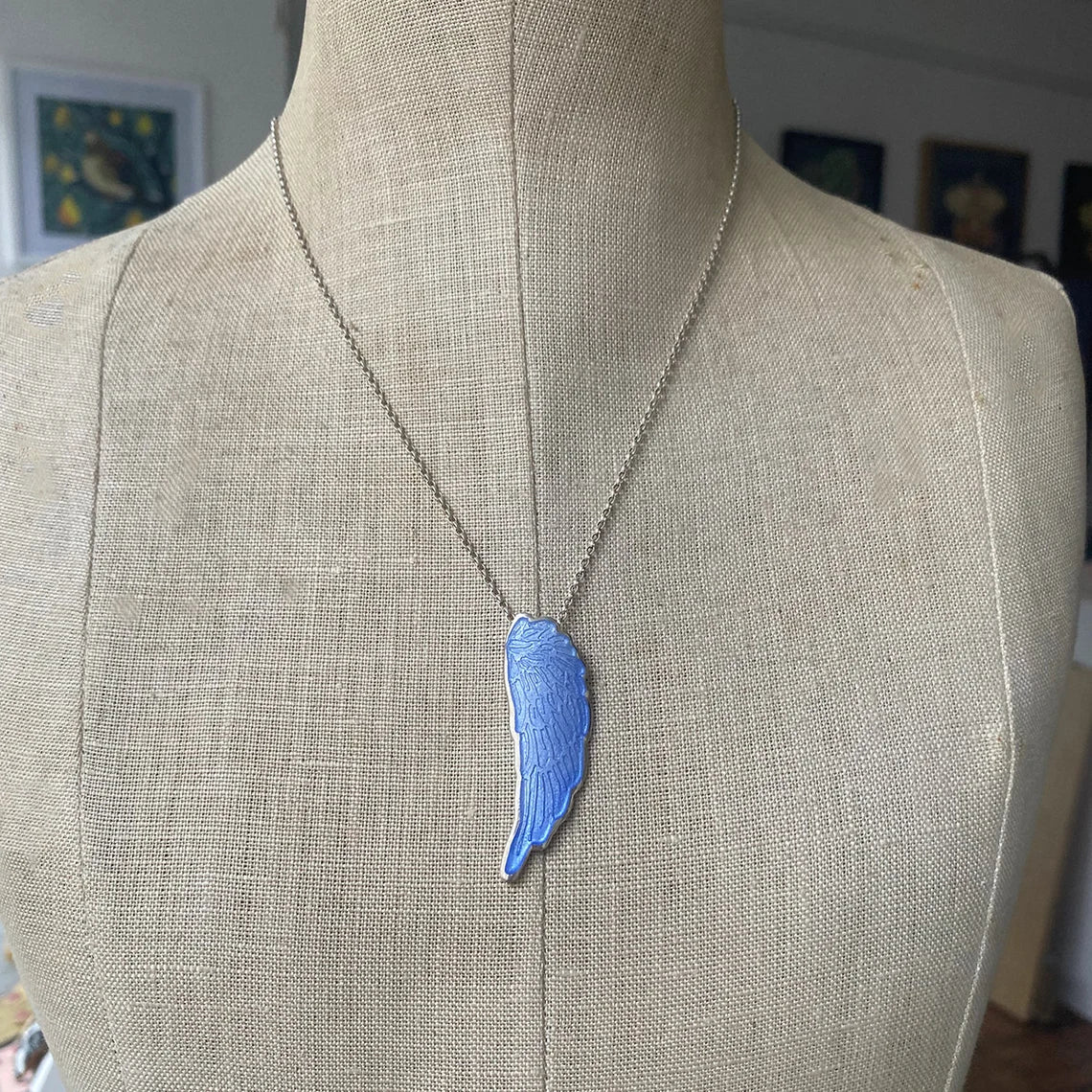 Blue Enamelled Angel Wing Pendant on a mannequin.