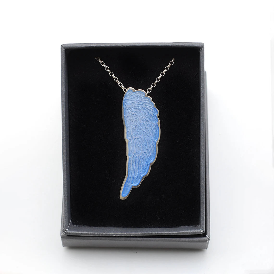 Blue Enamelled Angel Wing Pendant in a gift box, on a white background.