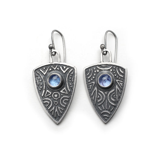 Triangular sheild earrings in etched silver with tanzanite cabochons, on a white background.