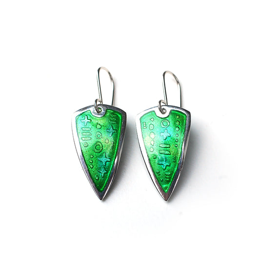 Silver earrings with green enamel over an etched pattern on a white background