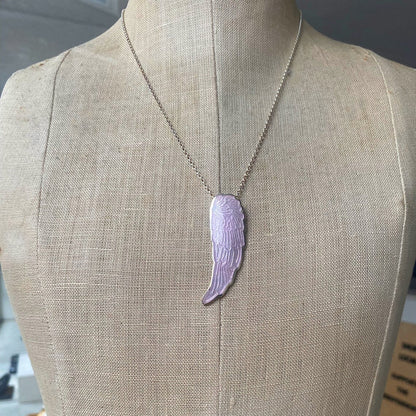 Silver and pink enamel angel wing pendant on a mannequin