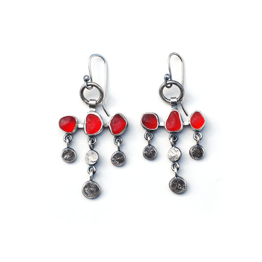 Dot and dangle red sea glass earrings on a white background.