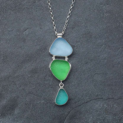 Triple sea glass pendant on a slate grey background