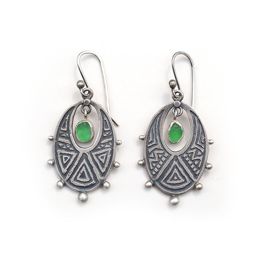 Etched silver earrings with green 
 sea glass,  on a white background.